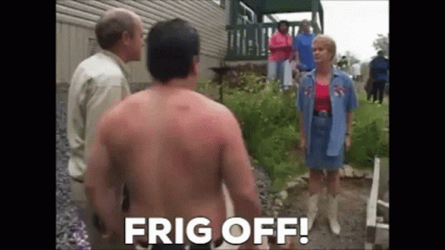A Shirtless Man Is Standing In Front Of A Group Of People And A Woman . GIF