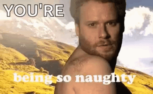 A Shirtless Man Is Standing In Front Of A Mountain With The Words `` You 'Re Being So Naughty '' Written On It . GIF