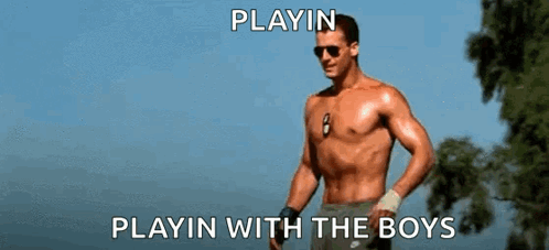 A Shirtless Man Is Standing In Front Of A Tree With The Words Playin Playin With The Boys Above Him GIF