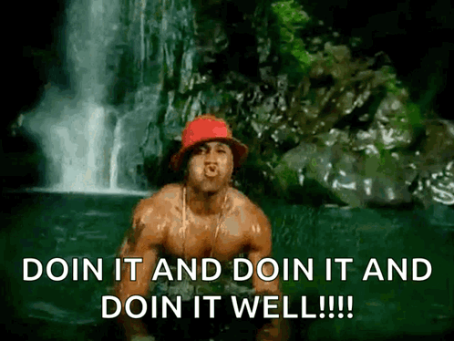 A Shirtless Man Is Standing In Front Of A Waterfall With The Words Doin It And Doin It And Doin It Well !!! GIF