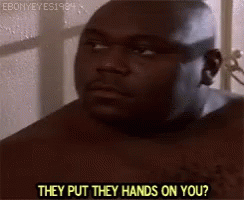 A Shirtless Man Is Standing In Front Of A Window Talking To Someone . GIF