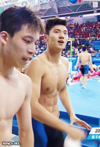 A Shirtless Man Is Standing Next To Another Shirtless Man With The Year 2014 On The Bottom Right GIF