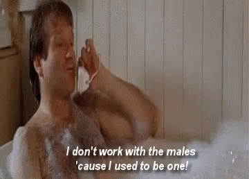 A Shirtless Man Is Taking A Bath In A Bathtub While Shaving His Beard . GIF