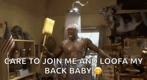 A Shirtless Man Is Taking A Shower And Holding A Yellow Sponge .. GIF