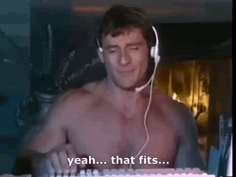 A Shirtless Man Is Wearing Headphones And Playing A Keyboard . GIF