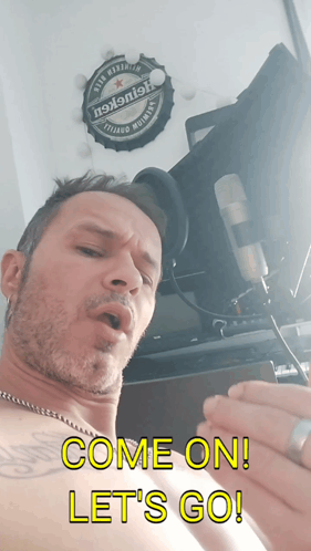 A Shirtless Man Singing Into A Microphone With The Words Come On Let 'S Go Below Him GIF