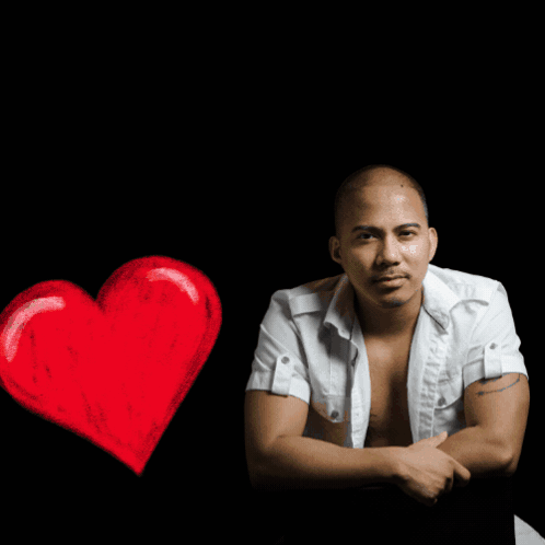 A Shirtless Man Sits In Front Of A Sign That Says R & R Music House GIF