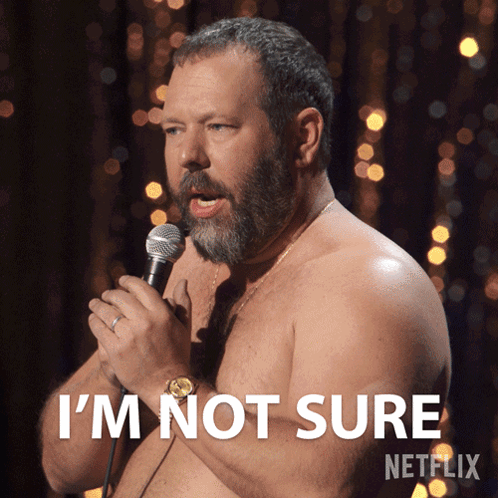 A Shirtless Man Speaking Into A Microphone With The Words I 'M Not Sure On The Bottom GIF