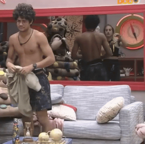 Shirtless Man Standing In Front Of Couch And Mirror GIF