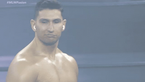 A Shirtless Man Stands In Front Of A Screen That Says #Mlwfusion GIF