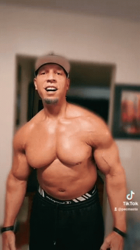 A Shirtless Man Wearing A Baseball Cap And Black Shorts Has A Tiktok Account GIF