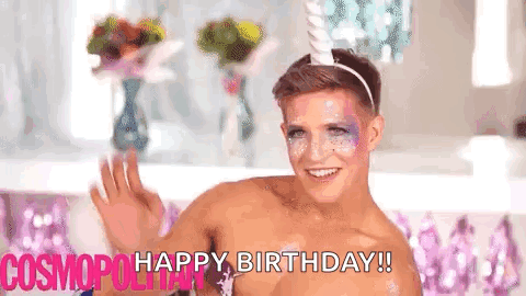 A Shirtless Man Wearing A Unicorn Headband And Makeup Is Waving . GIF