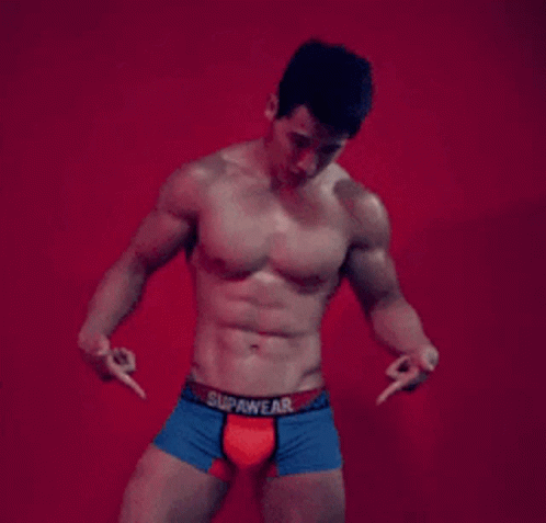 A Shirtless Man Wearing Blue And Red Boxer Shorts With The Word Supawear On The Waistband GIF