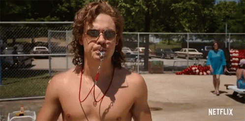 A Shirtless Man Wearing Sunglasses And A Life Preserver Stands In Front Of A Fence With Netflix Written On The Bottom GIF