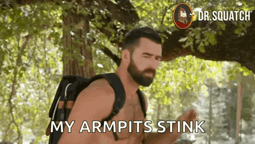 A Shirtless Man With A Backpack Says " My Armpits Stink " While Standing Under A Tree . GIF
