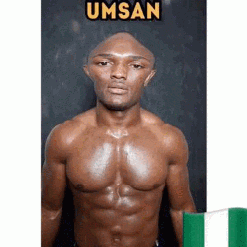 A Shirtless Man With A Bald Head Is Standing Next To A Green And White Flag . GIF
