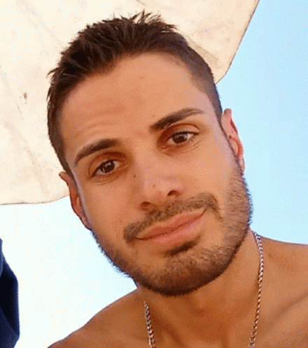 A Shirtless Man With A Beard And Chain Around His Neck GIF