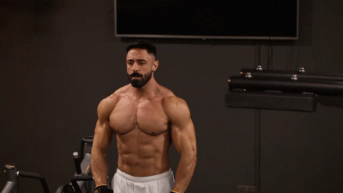 A Shirtless Man With A Beard Is Lifting A Barbell GIF