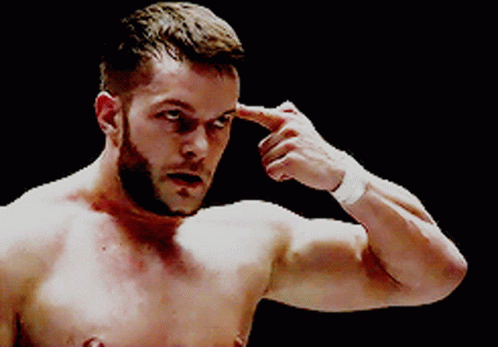 A Shirtless Man With A Beard Is Pointing His Finger At His Forehead GIF