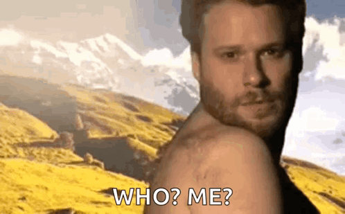A Shirtless Man With A Beard Is Standing In Front Of A Mountain And Asking Who ? Me ? GIF