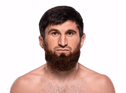 A Shirtless Man With A Beard Looks At The Camera With A Serious Look On His Face GIF