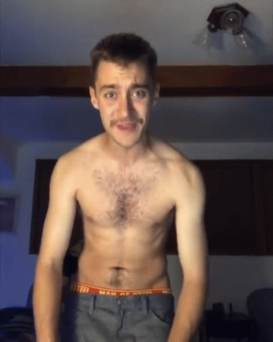 A Shirtless Man With A Mustache Is Wearing A Pair Of Underwear That Says Mail Of America GIF