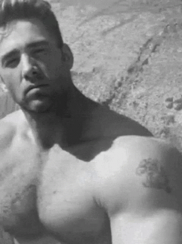 A Shirtless Man With A Tattoo On His Arm GIF
