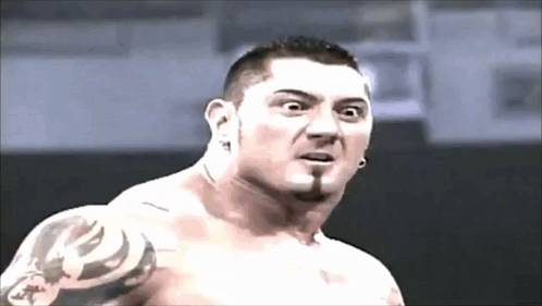 A Shirtless Man With A Tattoo On His Arm Is Making A Surprised Face GIF