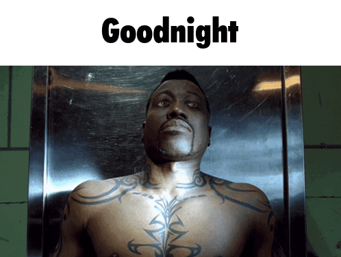 A Shirtless Man With A Tattoo On His Chest Is Laying In A Coffin With The Words Goodnight Below Him GIF