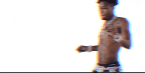A Shirtless Man With A Tattoo On His Chest Is Wearing Black Underwear GIF