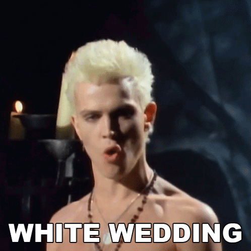 A Shirtless Man With Blonde Hair Is Singing A Song Called White Wedding GIF
