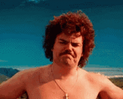 A Shirtless Man With Curly Hair And A Mustache Is Making An Angry Face GIF
