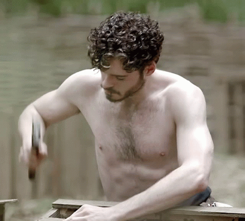 A Shirtless Man With Curly Hair Is Hammering Something GIF
