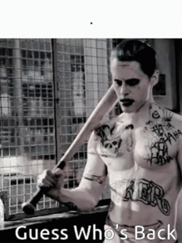 A Shirtless Man With Tattoos Is Holding A Baseball Bat And The Caption Guess Who 'S Back GIF