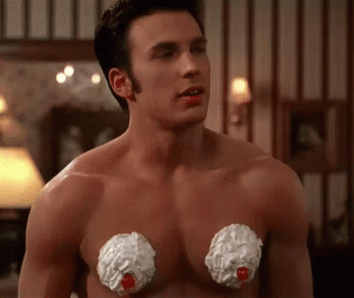 A Shirtless Man With Whipped Cream On His Chest Looks At The Camera GIF