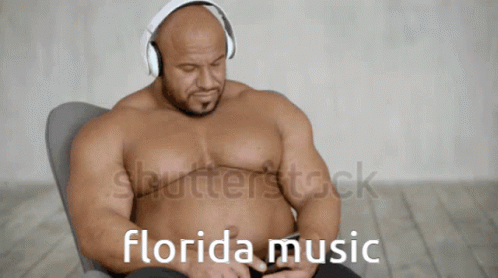 A Shirtless Muscular Man Wearing Headphones Is Listening To Florida Music GIF