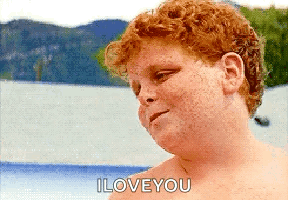 A Shirtless Red Haired Boy Says I Love You In Front Of A Body Of Water GIF