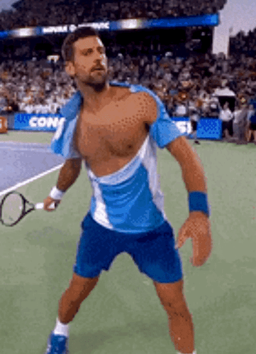 A Shirtless Tennis Player Is Holding A Tennis Racquet On A Court . GIF