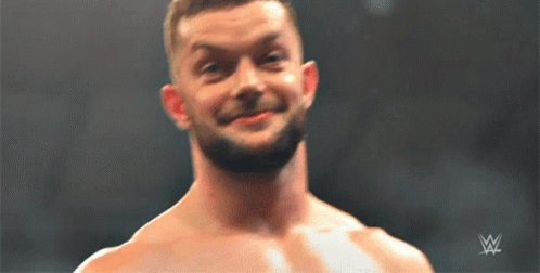 A Shirtless Wrestler Is Smiling In Front Of A Wwe Logo GIF