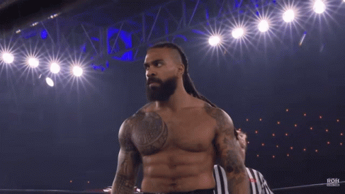 A Shirtless Wrestler Is Standing In A Ring With The Word Roh On The Bottom GIF