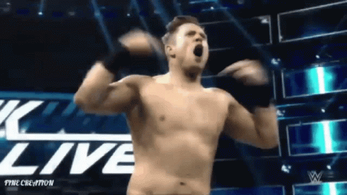 A Shirtless Wrestler Is Standing In Front Of A Sign That Says " Live " GIF