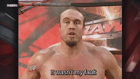 A Shirtless Wrestler Says " It Wasn 'T My Fault " In Front Of A Wrestling Ring GIF