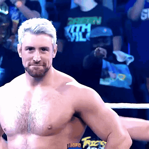 A Shirtless Wrestler Stands In Front Of A Crowd Wearing A Shirt That Says ' Shawn Michaels ' On It GIF