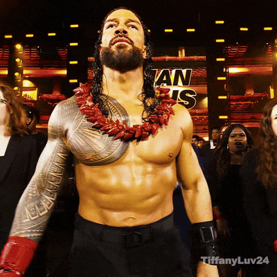 A Shirtless Wrestler Stands In Front Of A Sign That Says ' An Is ' On It GIF