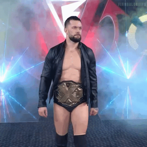 A Shirtless Wrestler Wearing A Belt With The Letters X On It GIF
