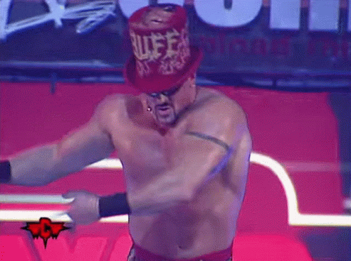 A Shirtless Wrestler Wearing A Red Top Hat With The Word Rules Written On It GIF