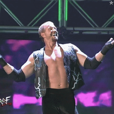 A Shirtless Wrestler Wearing A Vest That Says ' Pun ' On It GIF