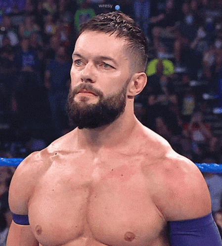 A Shirtless Wrestler With A Beard Is Standing In A Ring GIF