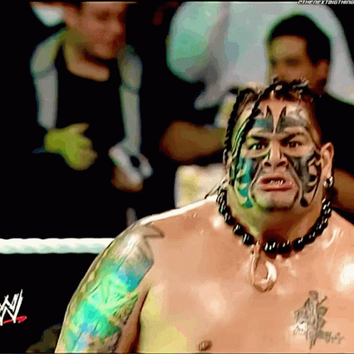 A Shirtless Wrestler With A Tattoo On His Arm And Face Has The Letter N On His Chest GIF