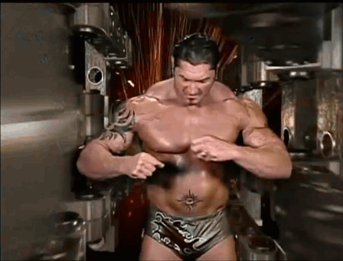 A Shirtless Wrestler With A Tattoo On His Stomach GIF
